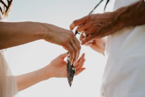 hands touching a tie