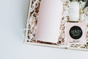 Product photography of a light pink water bottle beautifully packaged.