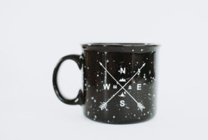 A black speckled ceramic mug.