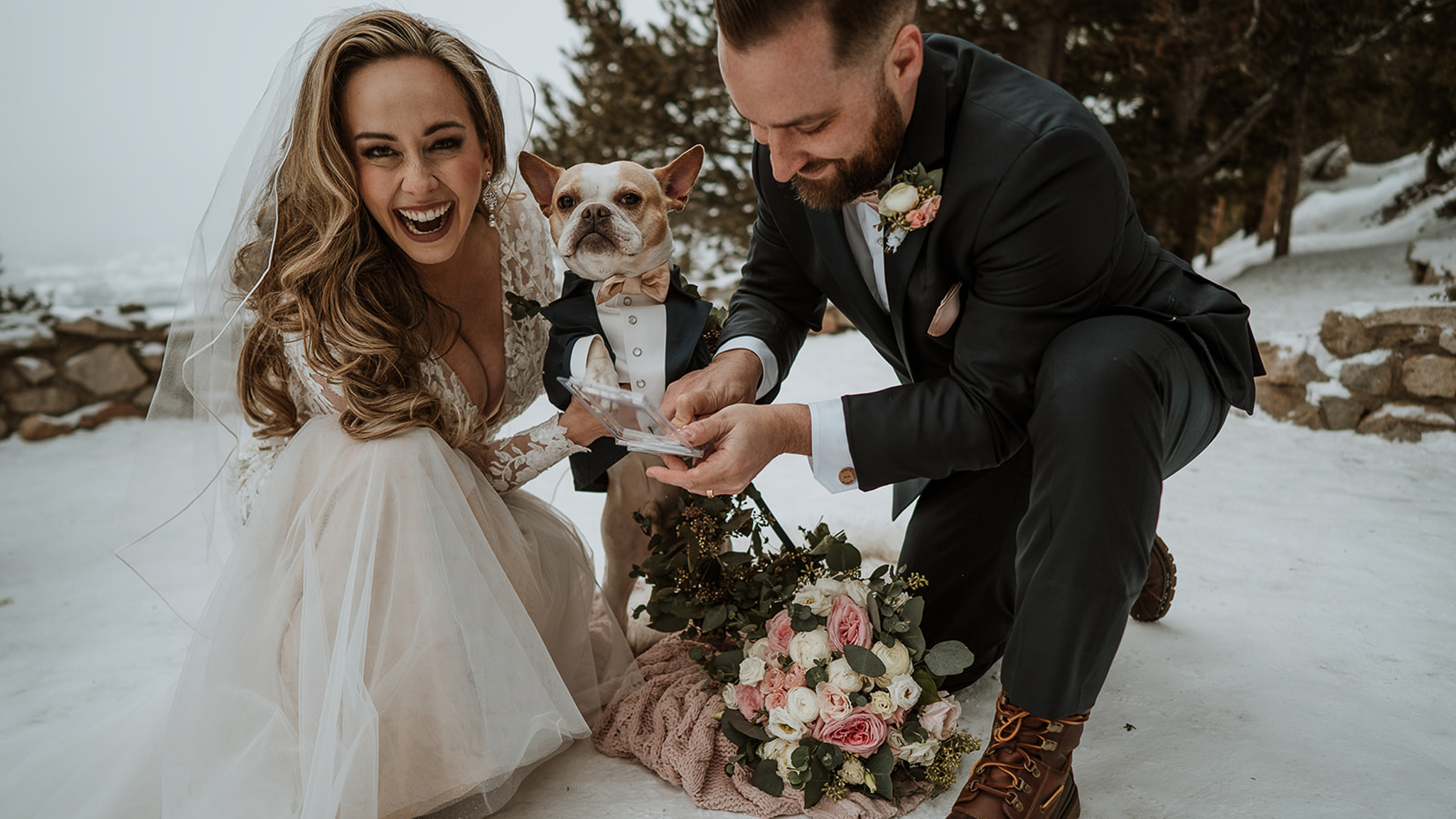 Angelina & Andy sign their marriage license with Bruno, their small dog, at their winter wedding at Sapphire Point in Breckenridge, CO.
