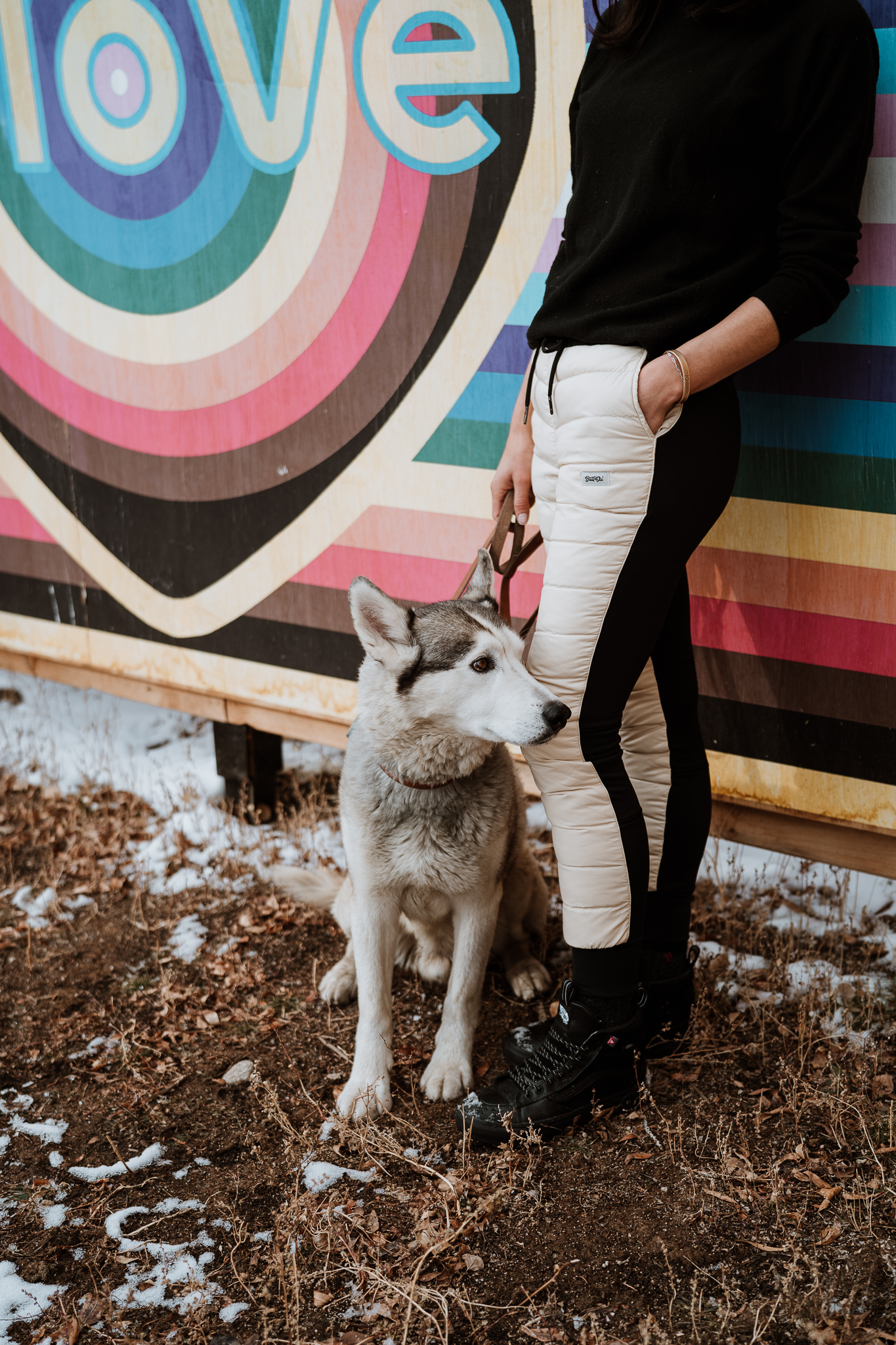 Kelly Mazanti, owner of Breckenridge outdoor brand, Buttnski, poses with husky, Drake.